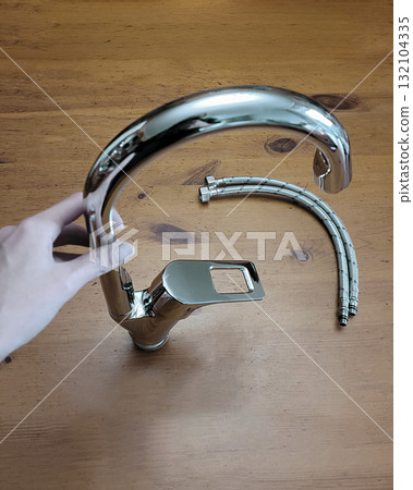 Silver Kitchen Faucet with Hoses in Hand Silver Kitchen Faucet with Hoses in Hand 132104335