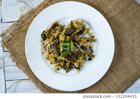 Italian dish Risotto. Garnish dish with mushrooms. Top view. Italian dish Risotto. Garnish dish with mushrooms. Top view. 132104433