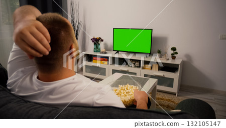 Watching Green Screen Chroma Key TV at home interior. Watching Green Screen Chroma Key TV at home interior. 132105147