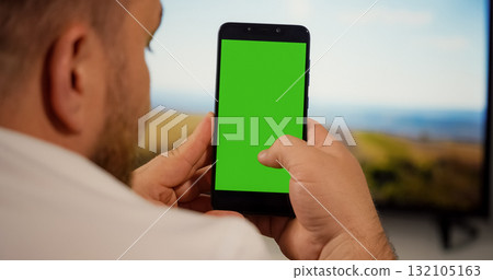 Man Using Smartphone with Green Screen for Copy Space Man Using Smartphone with Green Screen for Copy Space 132105163