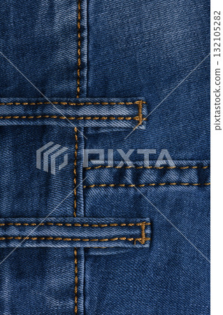Denim fabric with yellow thread seams, denim jacket, denim pants, for background or fabric sample sale. 132105282