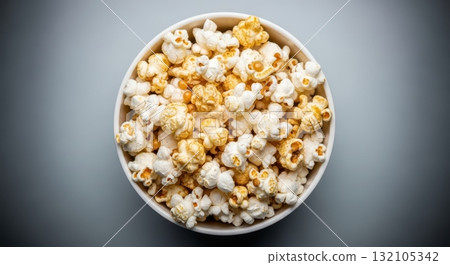 Delicious golden popcorn in white bowl against grey background 132105342