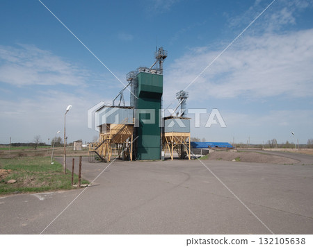 transport scene overview, industrial freight and grain storage, quiet transport hub with grain storage facilities, transport terminal featuring grain elevator and industrial surroundings 132105638
