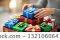 Hands arranging colorful wrapped gifts with ribbons for holiday celebrations Hands arranging colorful wrapped gifts with ribbons for holiday celebrations 132106064