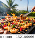 Tropical backyard barbecue: grilled skewers, fresh seafood, and vegetables by the ocean Tropical backyard barbecue: grilled skewers, fresh seafood, and vegetables by the ocean 132106066