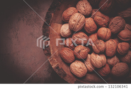 fresh walnut in a shell, wooden plate, top view, no people, fresh walnut in a shell, wooden plate, top view, no people, 132106341