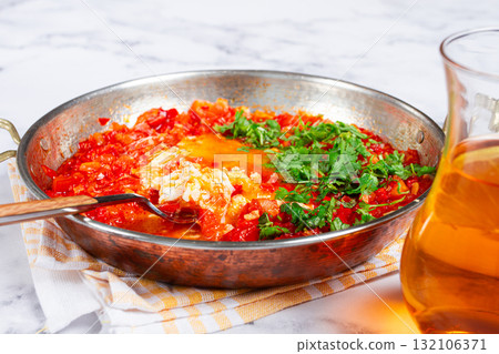 traditional Turkish dish, scrambled eggs with tomatoes, Menemen, with herbs, in a frying pan, close-up, no people, 132106371