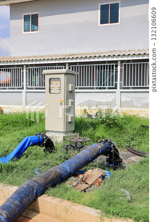 Dewatering pump with connected pipes and hoses of flood management system. Dewatering pump with connected pipes and hoses of flood management system. 132106609