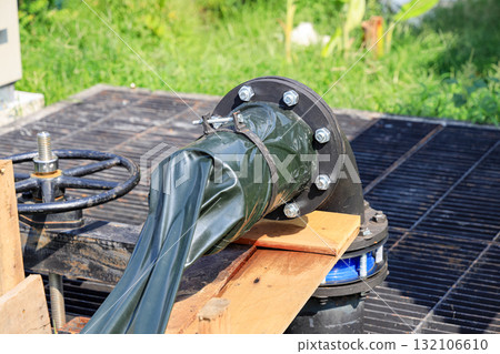 Dewatering pump with connected pipes and hoses of flood management system. Dewatering pump with connected pipes and hoses of flood management system. 132106610