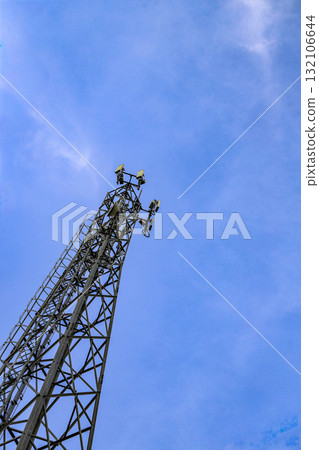 Wireless Communication Antenna pole, Mobile phone mast antenna pole on top of dilapidated building. Wireless Communication Antenna pole, Mobile phone mast antenna pole on top of dilapidated building. 132106644