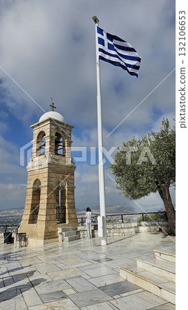 Stone bell tower with a white dome and Greek flag 132106653