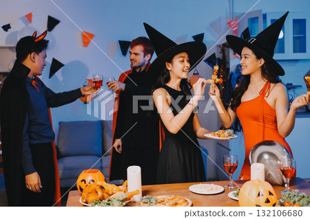 Joyful office Halloween party with coworkers in costumes, celebrating with drinks and laughter, fostering teamwork and festive spirit Joyful office Halloween party with coworkers in costumes, celebrating with drinks and laughter, fostering teamwork and festive spirit 132106680