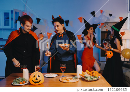 Joyful office Halloween party with coworkers in costumes, celebrating with drinks and laughter, fostering teamwork and festive spirit 132106685