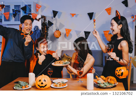 Joyful office Halloween party with coworkers in costumes, celebrating with drinks and laughter, fostering teamwork and festive spirit 132106702