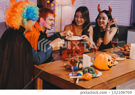 Joyful office Halloween party with coworkers in costumes, celebrating with drinks and laughter, fostering teamwork and festive spirit 132106709