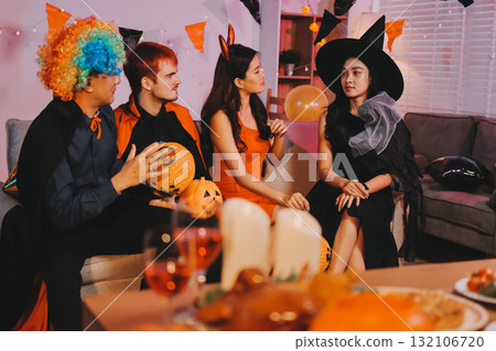 Joyful office Halloween party with coworkers in costumes, celebrating with drinks and laughter, fostering teamwork and festive spirit 132106720