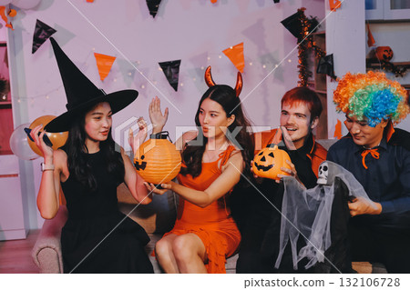 Joyful office Halloween party with coworkers in costumes, celebrating with drinks and laughter, fostering teamwork and festive spirit Joyful office Halloween party with coworkers in costumes, celebrating with drinks and laughter, fostering teamwork and festive spirit 132106728