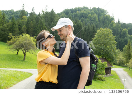 Happy married couple hugging and walking in nature. Happy married couple hugging and walking in nature. 132106766
