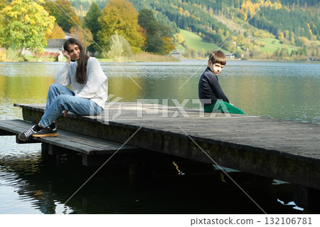 Mother and Son Sitting Apart. Parenting Conflict, Misunderstanding and Emotional Distance Mother and Son Sitting Apart. Parenting Conflict, Misunderstanding and Emotional Distance 132106781