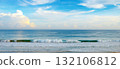 Tranquil Seascape With Gentle Waves Rolling Onto Sandy Beach Under Clear Blue Sky Horizontal 132106812