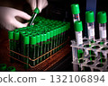 Scientist's Gloved Hand Working with Test Tubes in Laboratory 132106894