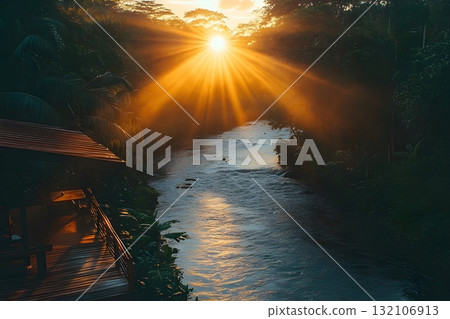 Sunrise bursting through tropical canopy casting golden rays over a rushing jungle river Sunrise bursting through tropical canopy casting golden rays over a rushing jungle river 132106913