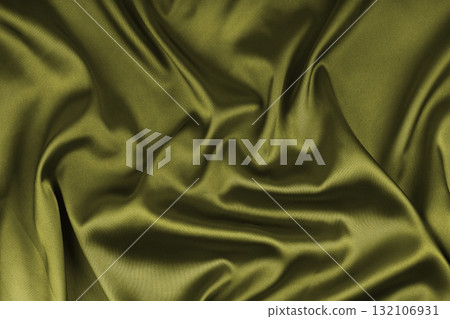 Crumpled, wrinkled khaki colored glossy silk satin texture. Shiny smooth fabric with soft folds Crumpled, wrinkled khaki colored glossy silk satin texture. Shiny smooth fabric with soft folds 132106931