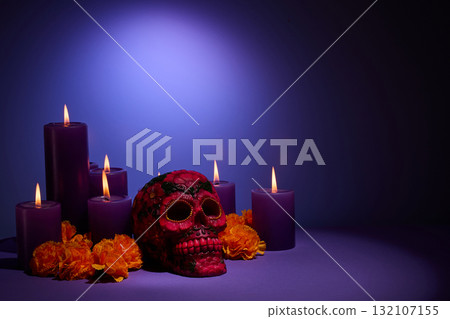 Dia de Muertos Ambiance. Vibrant purple candles and colorful skull surrounded by marigold flowers, Dia de Muertos Ambiance. Vibrant purple candles and colorful skull surrounded by marigold flowers, 132107155