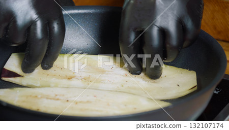 Frying Sliced Eggplant in the Hot Pan Delicious Vegetables. Frying Sliced Eggplant in the Hot Pan Delicious Vegetables. 132107174