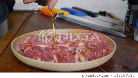 Seasoning Raw Beef Meat. Close Up Cooking Beef Meat. Professional Meat Cooking. 132107183