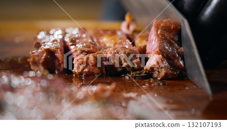 Chef Cutting a Medium Cooked Beef Looks Very Tasty. Food Art. Chef Cutting a Medium Cooked Beef Looks Very Tasty. Food Art. 132107193