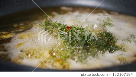 Cook in Pan. Frying Herbs Thyme with Butter for Meat Cook in Pan. Frying Herbs Thyme with Butter for Meat 132107194