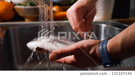 Cleaning Fish on Water Jet Before Cooking. Gilt-head bream fish. Cleaning Fish on Water Jet Before Cooking. Gilt-head bream fish. 132107240