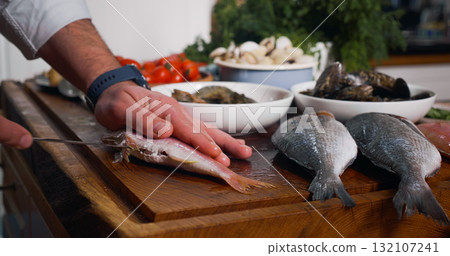 Cleaning Fish Before Cooking. Sea Food on a wood chipper Cleaning Fish Before Cooking. Sea Food on a wood chipper 132107241