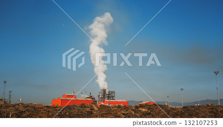 Industrial Factory Pollutes. Smoke on blue sky background. Industrial Factory Pollutes. Smoke on blue sky background. 132107253