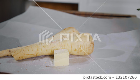 Seasoning the roots of vegetables like parsley or parsnip preparing for cooking. Seasoning the roots of vegetables like parsley or parsnip preparing for cooking. 132107260