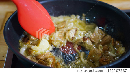 Cooking Tasty Meal Concept. Frying Mushroom Boletus and Onion in a Hot Pan 132107287