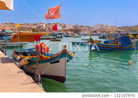 Colorful luzzu boat on Marsaxlokk promenade, Malta 132107970
