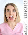 Portrait of a woman holding a pill on her tongue. The danger of using medications without a doctor's prescription 132108207