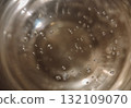 An abstract, high-angle macro close-up shot looking down into a glass containing Champagne or sparkling wine 132109070