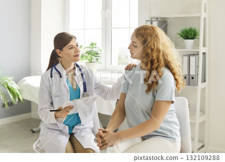 Doctor Or Nurse Welcomes Female Patient In Hospital Office Doctor Or Nurse Welcomes Female Patient In Hospital Office 132109288