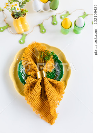 Easter celebration concept. Top view vertical green yellow plate eggs, isolated background, banner 132109423
