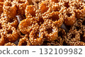An extreme close-up, mouth-watering video of a stack of golden-brown Chebakia pastries, a traditional Maghrebi sweet. 132109982