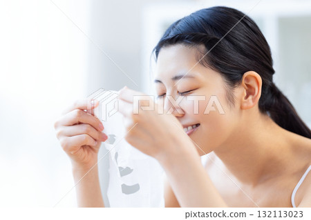 A woman holding a face pack A woman holding a face pack 132113023
