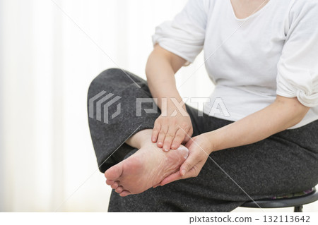 Senior woman applying cream to dry heels Senior woman applying cream to dry heels 132113642