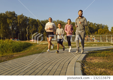 Happy Family Jogging Together at Sunset in City Park Happy Family Jogging Together at Sunset in City Park 132113879