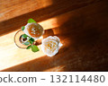 Yellow beautiful blooming rose in glass vase under window light on wooden table. 132114480