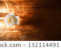 Yellow beautiful blooming rose in glass vase under window light on wooden table. 132114491