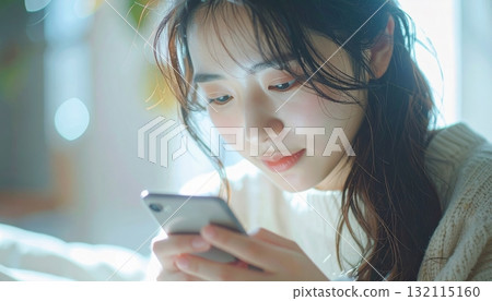 Woman operating a smartphone 132115160