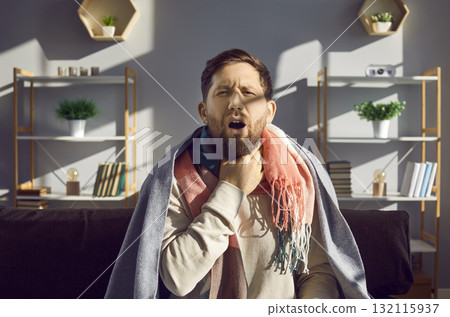 Sick man with touching his neck suffering from sore throat Sick man with touching his neck suffering from sore throat 132115937